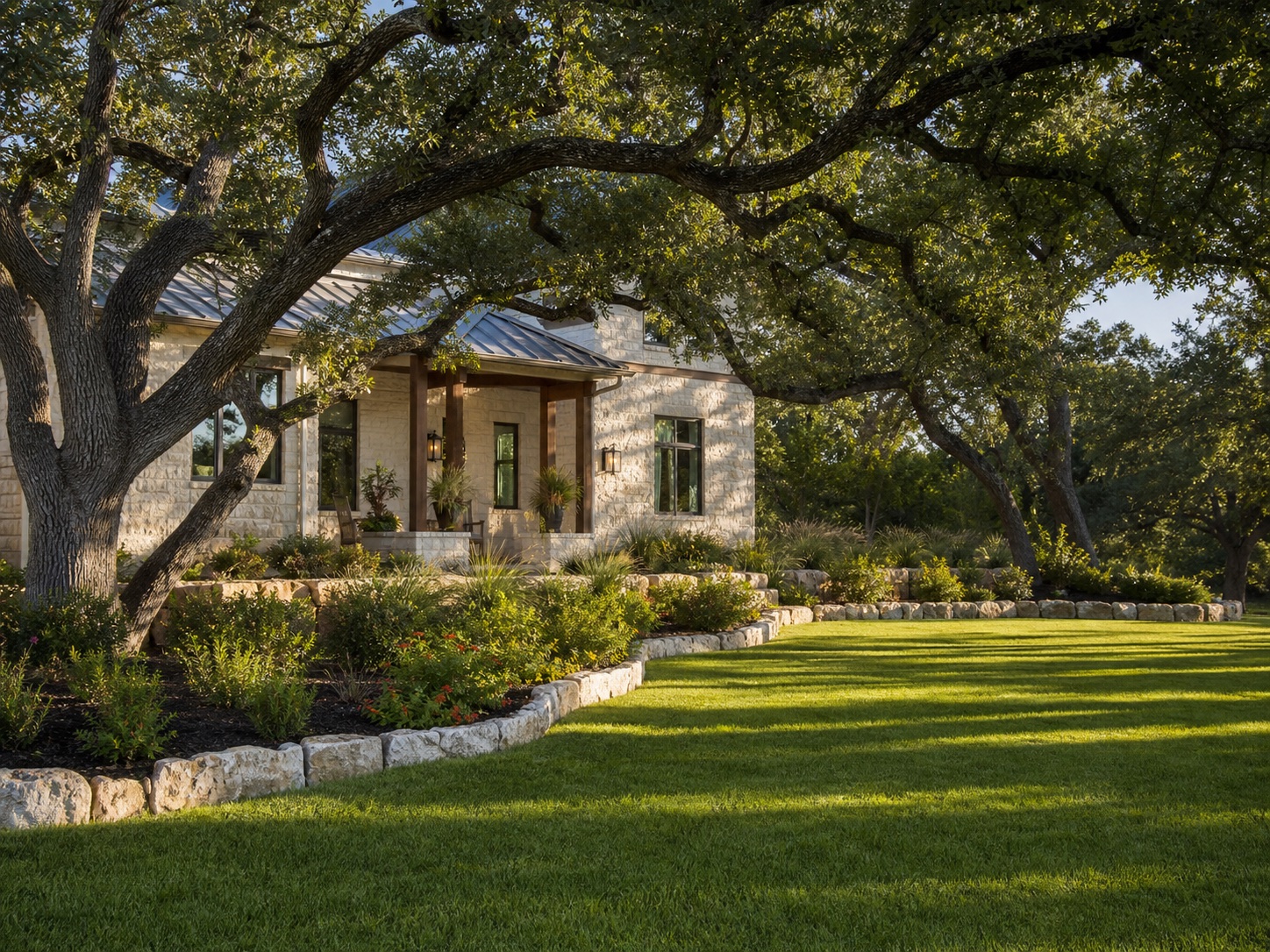 A carefully maintained lawn surrounding a limestone Hill Country home under oak trees.